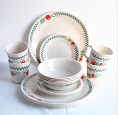 a white table topped with dishes and cups