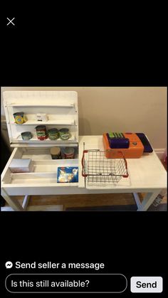 an open refrigerator sitting on top of a white table next to a shelf filled with food