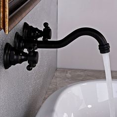 a faucet with water running from it's spout in a bathroom