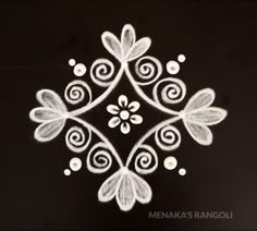 an artistic design made out of white chalk on a black surface with the words meenaka's rangoli written in it