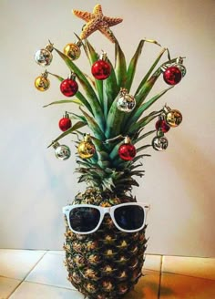 a pineapple decorated with christmas ornaments and sunglasses