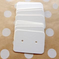 several pieces of white paper are stacked on top of each other with holes in the middle