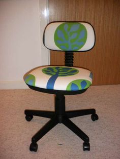 an office chair with a green and blue flower design on it's seat cushion