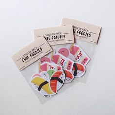 four stickers with sushi on them are sitting next to each other in front of a white background