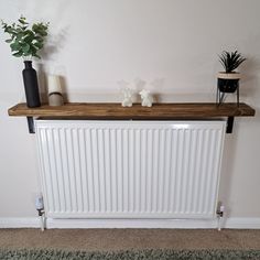 a radiator with two vases on top of it next to a wall