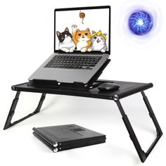 an open laptop computer sitting on top of a folding table with cats and dogs drawn on the screen