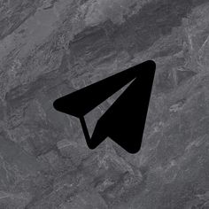 an airplane logo is shown on the side of a gray marble wall with black lines