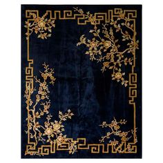 a blue rug with gold flowers and vines on the border, in front of a white background