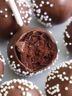 chocolate covered desserts with white sprinkles on a plate