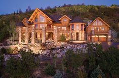 a large log home lit up at night