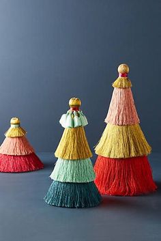 three different colored tassels sitting next to each other on top of a table