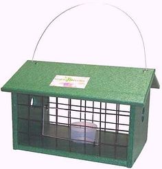 a green bird house with a plastic roof