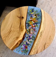 a wooden table with flowers painted on it