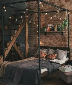 a bed sitting next to a brick wall in a bedroom