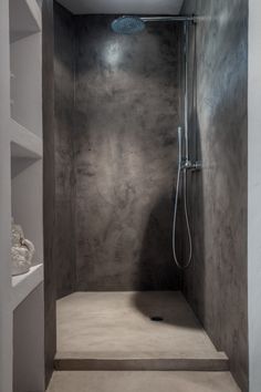 a walk in shower sitting inside of a bathroom