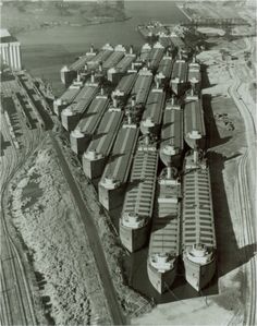 an aerial view of cargo ships docked at the port of long beach, ca 1950