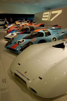 a group of race cars on display in a museum