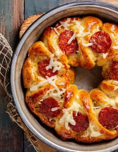 a pepperoni bundt cake in a pan on top of a wooden table next to a piece of string