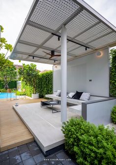 an outdoor living area next to a swimming pool