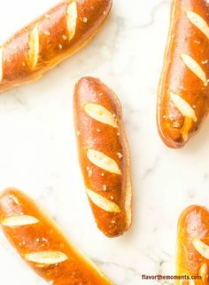 hotdogs with mustard and ketchup sitting on a marble surface