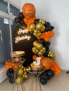 a birthday decoration with balloons and basketballs