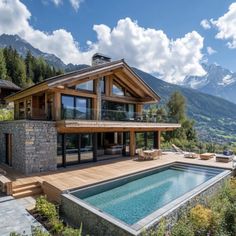 a house with a pool in front of it and mountains in the backround