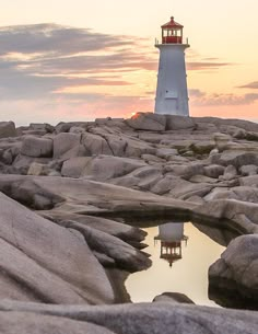 a light house sitting on top of a rocky hill