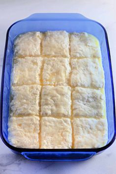 a blue casserole dish filled with squares of food