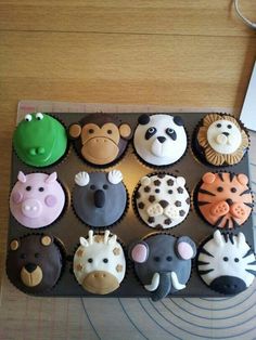 twelve cupcakes in the shape of different animals