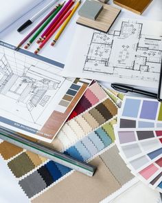 a table topped with lots of different types of color swatches and pencils on top of paper