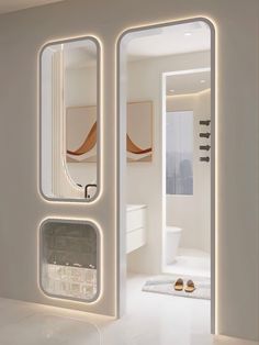 the interior of a modern bathroom with white walls and flooring, lighted by led lights