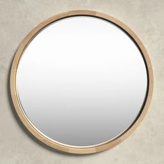 a round mirror hanging on the wall