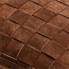 a close up view of the texture of a brown leather material with squares and lines