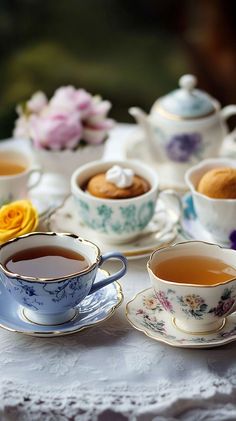 several tea cups and saucers on a table