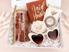 a gift box with sunglasses, book and other items