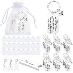 an assortment of personalized key chains and tags in clear plastic bags with white ribbon