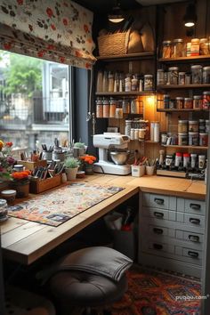 a kitchen with lots of pots and pans on the counter next to a window