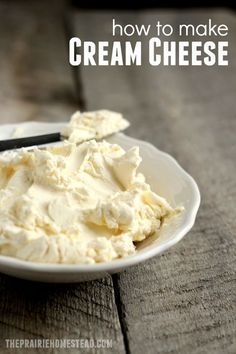 a white bowl filled with cream cheese on top of a wooden table