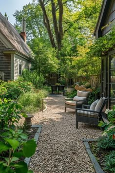 an outdoor patio with chairs and gravel path leading to the back yard, surrounded by greenery