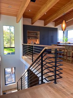 an open floor plan with stairs leading up to the kitchen