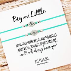 two bracelets with words on them sitting next to a card that says, big and little