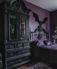 a bedroom with purple walls and an ornate black bed in the middle, along with a gothic - style dresser