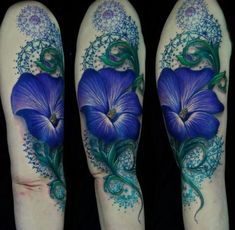 three tattoos with blue flowers and vines on their arms, one is in the shape of a flower