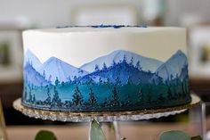 a blue and white cake sitting on top of a table