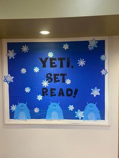 a blue sign that says yet, set read with snowflakes on the window