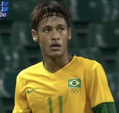 a young man in a yellow and green soccer uniform