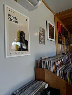 a record store with various records on the wall and in front of it is a poster that reads frank ocean