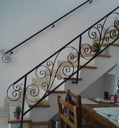 the stairs are made of wood and wrought iron