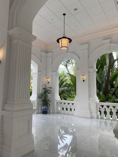 a large white room with columns and windows