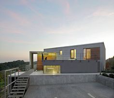 a modern house with stairs leading up to it